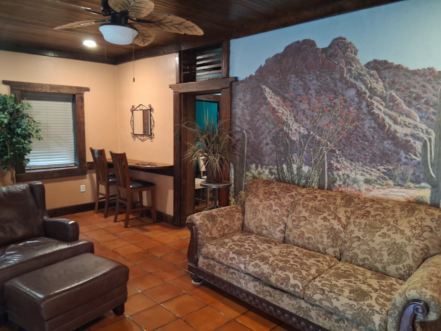 Living room with sofa, massage chair and desert mural