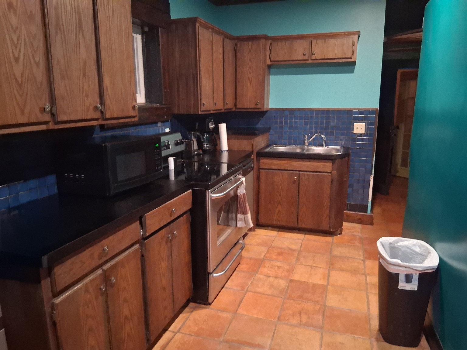 Full kitchen with stove, microwave, refrigerator and coffee maker